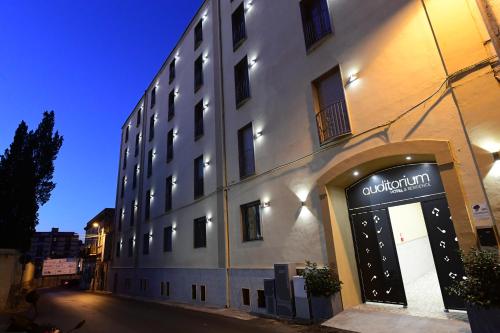a building with a sign on the side of it at Hotel Auditorium in Bari