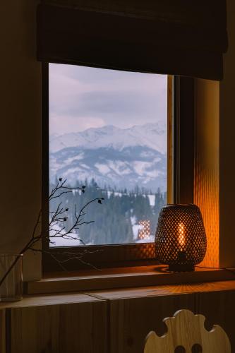 a window with a view of a snow covered mountain at Osada Matygówka in Gliczarów
