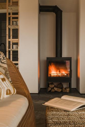 a living room with a fireplace and a couch at Osada Matygówka in Gliczarów