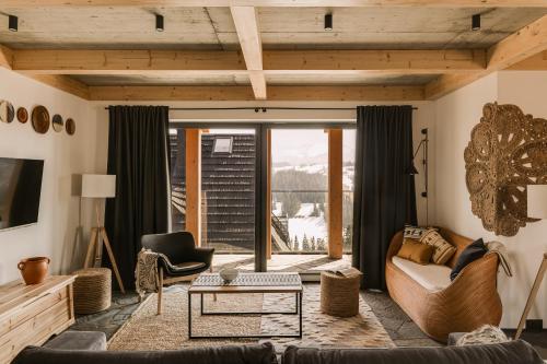 a living room with a couch and a table at Osada Matygówka in Gliczarów