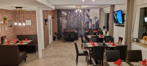 a restaurant with tables and chairs with red cones on them at Hakans Moselblick Ferienwohnung in Treis-Karden