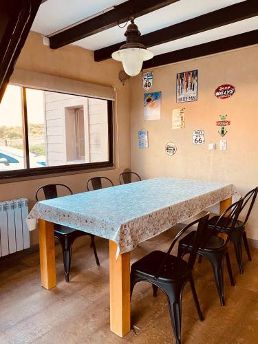 a table in a room with chairs around it at Casas De Montaña Las Leñas Los Molles in Los Molles