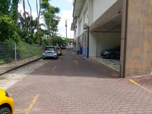 a street with cars parked on the side of a building at The Viana Apartment 1 in Kota Bharu
