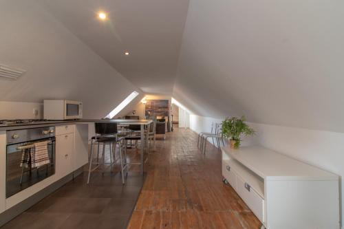 a kitchen with white cabinets and a counter top at Happy Reception in Lisbon