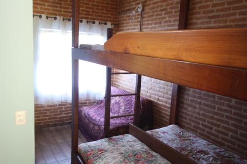 Una cama o camas en una habitación de Pousada Campestre Sítio da Lua