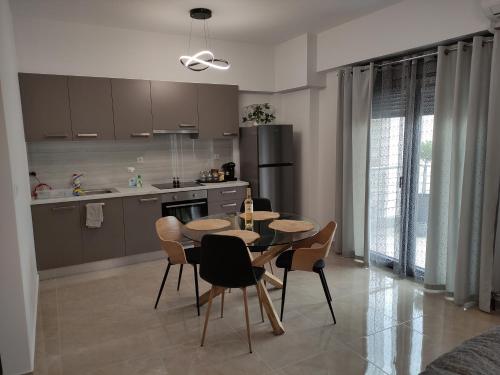 a kitchen and dining room with a table and chairs at Grey Swan - Modern & Stylish apartment with Private Parking in Volos