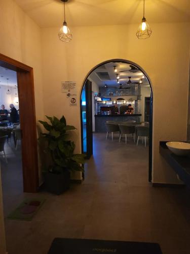an archway in a restaurant with a table and chairs at Hotel Oasis-Dream Holidays - La Petite France in San Bernardino