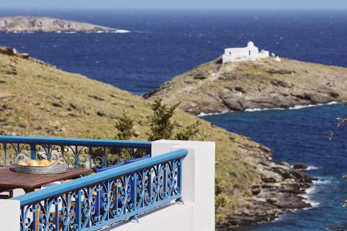 a blue and white balcony with a view of the ocean at Tramontana Suites in Áyios Stéfanos