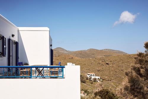 a balcony of a building with a view of a hill at Tramontana Suites in Áyios Stéfanos