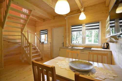 a kitchen and dining room with a table in a cabin at Holiday resort in Pobierowo for 6 persons in Pobierowo
