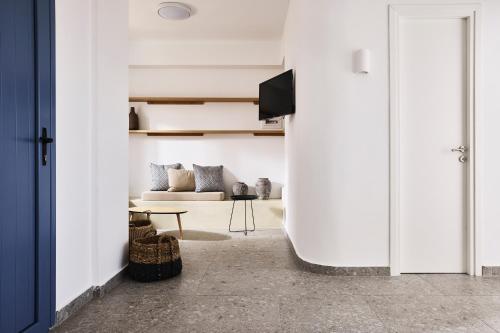 a living room with a couch and a table at Tramontana Suites in Áyios Stéfanos