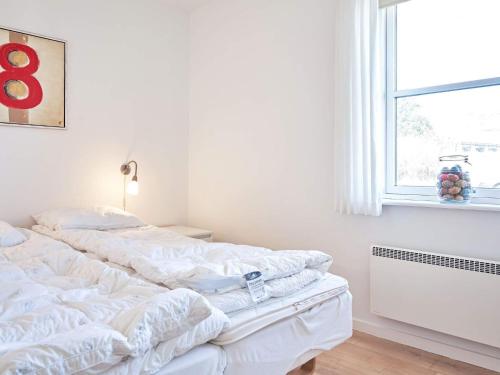 a bedroom with two white beds and a window at 4 person holiday home in Allinge-By Traum in Allinge