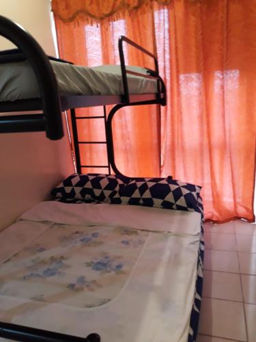 Ce lit superposé se trouve dans un dortoir doté d'une fenêtre. dans l'établissement Tagaytay-Cityland Prime-good for 6pax, à Tagaytay