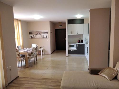 a living room and kitchen with a couch and a table at Victoria's apartments Nesebar in Nesebar
