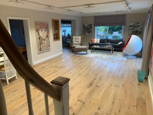 a living room with wood floors and a staircase at Harmony House in Handewitt