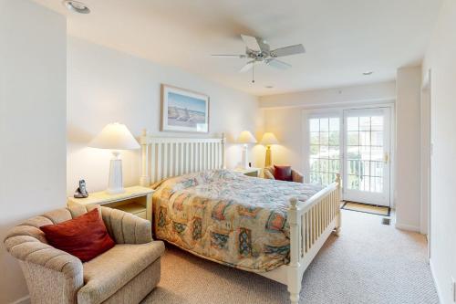 a bedroom with a bed and a chair at Bayside Bethany Lakes N Mill 89 in Ocean View