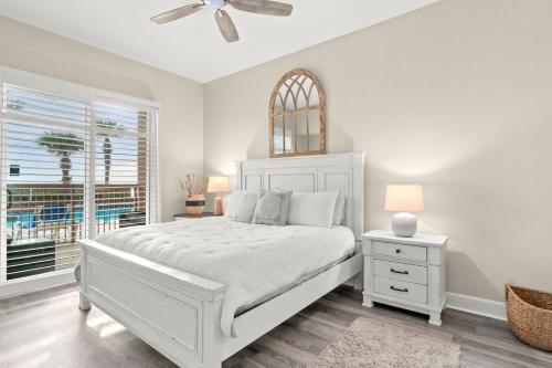 a white bedroom with a white bed and a window at Sunrise Beach Resort V in Panama City Beach