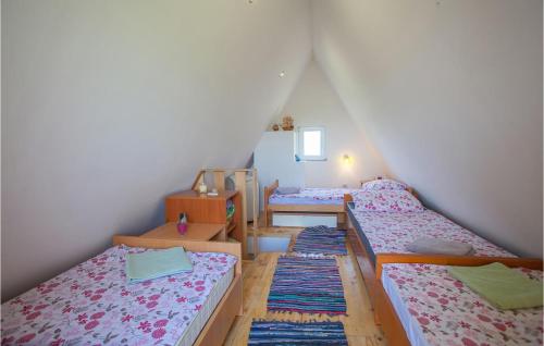 a room with four beds in a attic at Amazing Home In Opatovac With Wifi in Opatovac