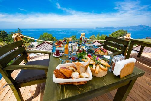 a picnic table with food on it on a deck at Vista Del Amor Faralya in Fethiye