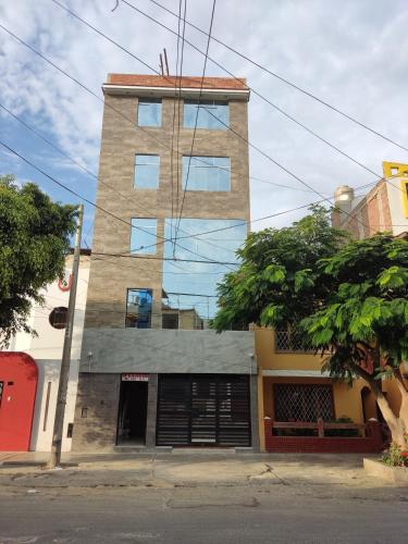 a tall brick building with a garage at D' Barrig in Trujillo