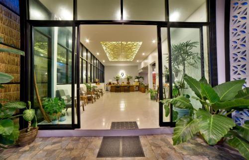 a hallway with potted plants in a building at Home at 9 in Ban Klang (4)