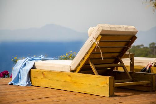 a bed sitting on top of a wooden box on a deck at Vista Del Amor Faralya in Fethiye