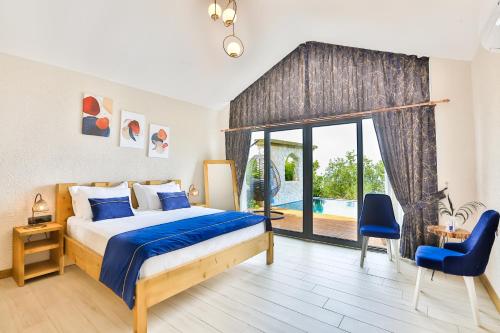 a bedroom with a bed and a sliding glass door at Vista Del Amor Faralya in Fethiye
