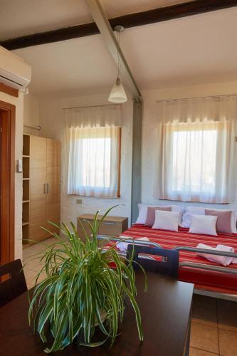 a bedroom with two beds and a potted plant at Villaggio San Paolo in Cavallino-Treporti
