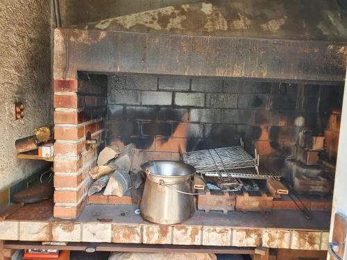 a metal pot sitting in a brick oven at Holiday Home Modruš in Modruš