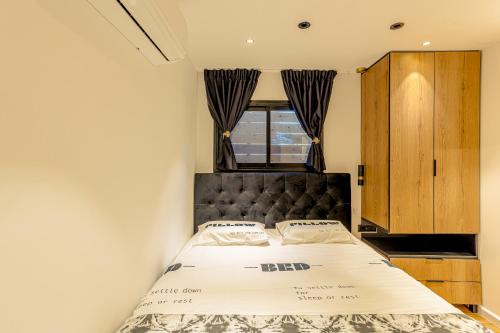 a bedroom with a bed and a window at orel's Top apartment in Eilat
