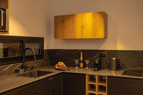 a kitchen with a sink and a bowl of fruit at orel's Top apartment in Eilat
