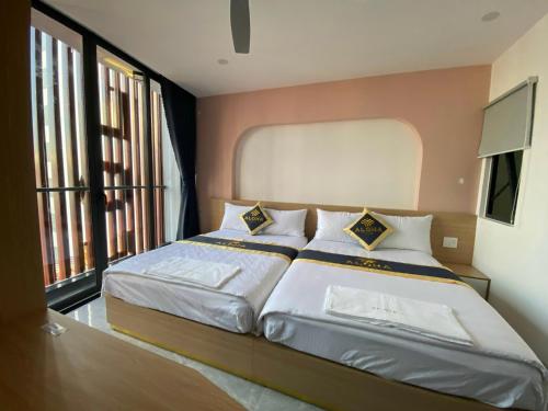Postel nebo postele na pokoji v ubytování Aloha Hotel Vung Tau