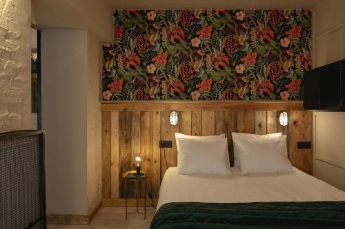 een slaapkamer met een bed met bloemenbehang aan de muur bij City Garage Apartment - Lwowska 9 in Warschau