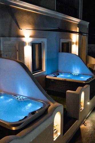 a bath room with a tub in a room at Villa Galaxy Santorini in Fira