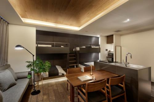 a kitchen and living room with a table and a couch at 20 PIECES in Kyoto