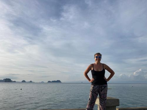 a woman standing on a pier near the water at Connexion in Ko Yao Noi