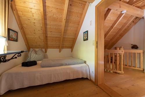 a bedroom with a bed in a room with wooden ceilings at Chalet Abnona in Wieden