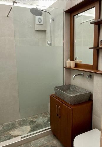 a bathroom with a sink and a shower at Aegean Sunset in Damouchari