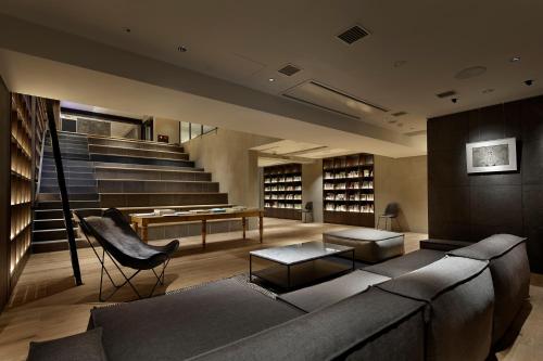 a living room with a couch and a table at TUNE STAY KYOTO in Kyoto