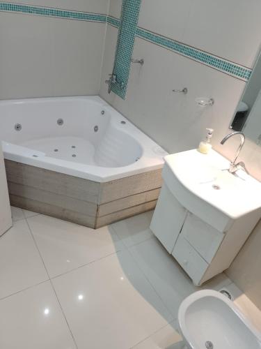 a bathroom with a tub and a toilet and a sink at JAP in Río Gallegos