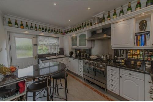 a large kitchen with a table and chairs in it at Morning Glory in Bolton