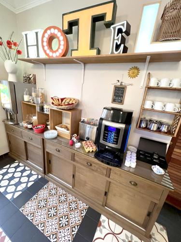 a coffee shop with a coffee maker on a counter at Hôtel Cecil Adults only in Juan-les-Pins