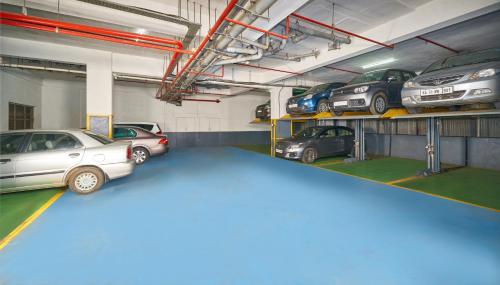 a garage with several cars parked in it at Hotel Vrishali Executive in Kolhapur
