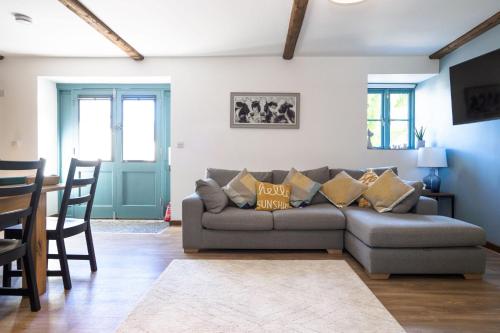 a living room with a couch and a table at Pendeen in Falmouth