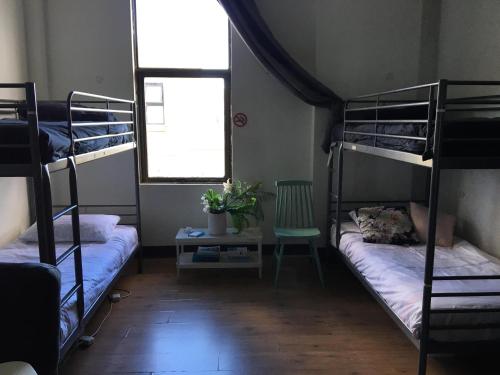a room with two bunk beds and a window at EBS Sydney Hostel in Sydney