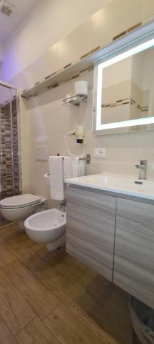 a white bathroom with a toilet and a sink at Hotel Biagi & Residence in Lido di Camaiore