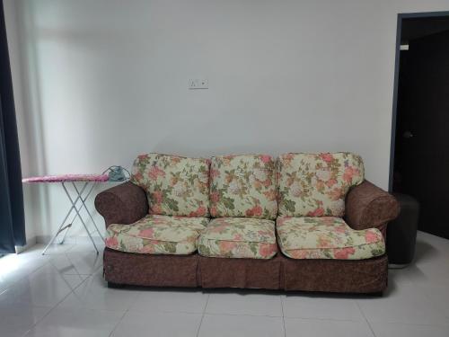 a brown couch sitting in a living room at Juliana Homestay in Jitra