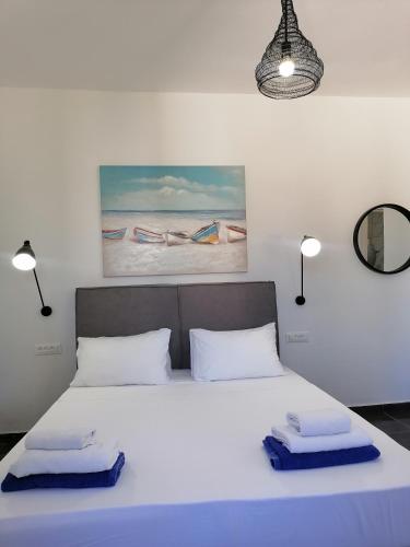 a bedroom with a bed with two towels on it at Villa Mare by Delfinia Resort in Kolymbia