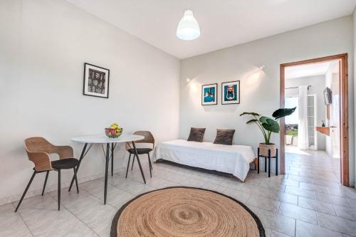 a bedroom with a bed and a table and chairs at Elena-Stella Apartments Arillas Corfu in Arillas