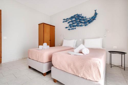 two beds sitting next to each other in a room at Elena-Stella Apartments Arillas Corfu in Arillas